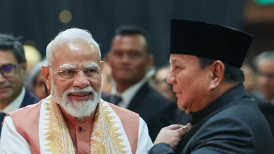 Prime Minister Narendra Modi and Indonesian President Prabowo Subianto share a light-hearted conversation about the lucky number 8 during the Indian diaspora event in Jakarta, highlighting the growing friendship between India and Indonesia.