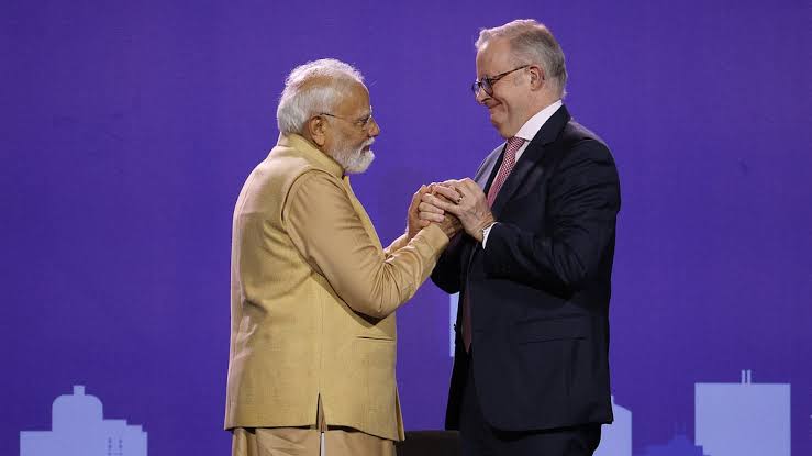 Prime Minister Narendra Modi during his Australia visit as media cameras capture the event after an Australian journalist comments on his press conference approach.